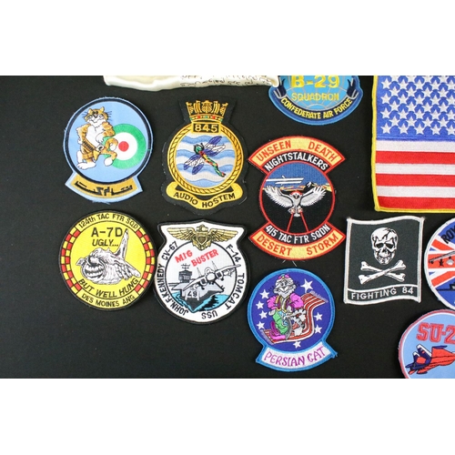 148 - A large collection of reproduction military and air force cloth badges and patches.