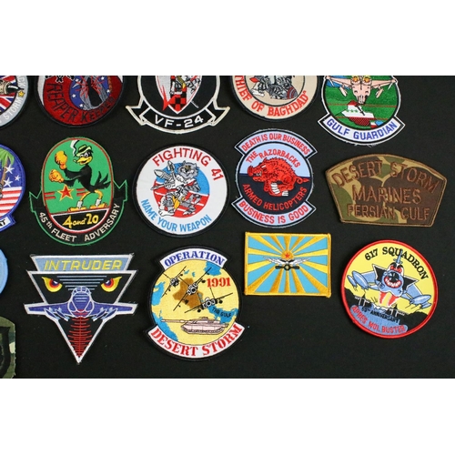 148 - A large collection of reproduction military and air force cloth badges and patches.