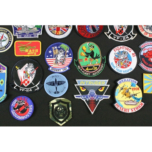 148 - A large collection of reproduction military and air force cloth badges and patches.