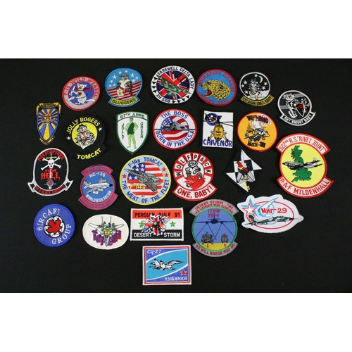 148 - A large collection of reproduction military and air force cloth badges and patches.