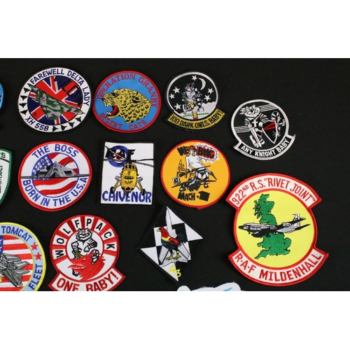 148 - A large collection of reproduction military and air force cloth badges and patches.