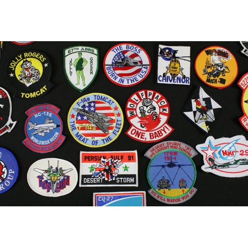 148 - A large collection of reproduction military and air force cloth badges and patches.