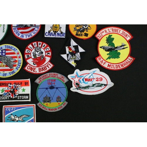 148 - A large collection of reproduction military and air force cloth badges and patches.