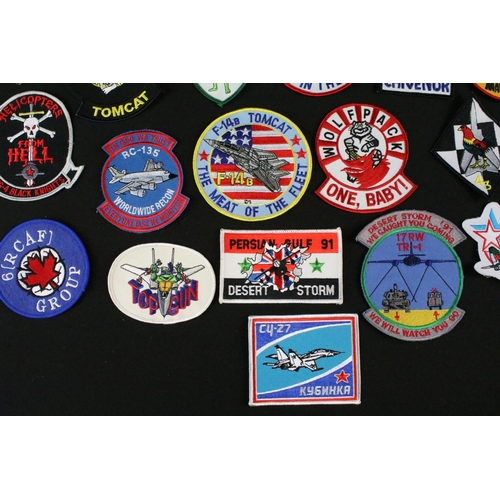 148 - A large collection of reproduction military and air force cloth badges and patches.