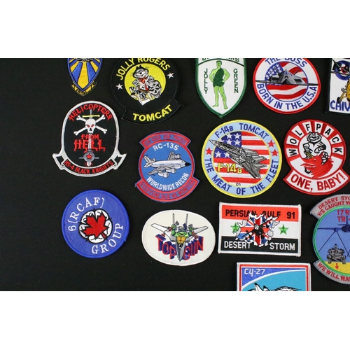 148 - A large collection of reproduction military and air force cloth badges and patches.