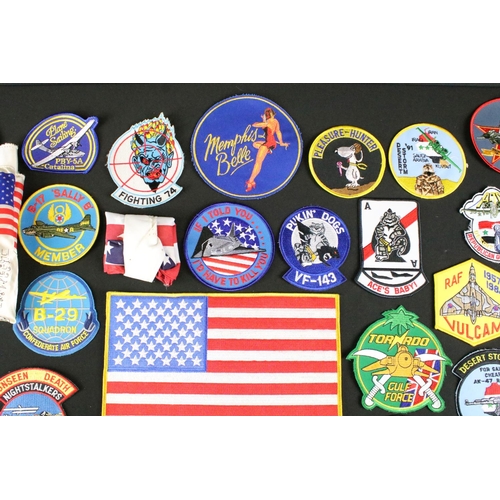 148 - A large collection of reproduction military and air force cloth badges and patches.