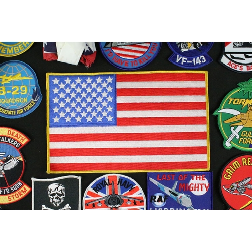 148 - A large collection of reproduction military and air force cloth badges and patches.