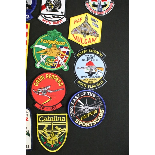 148 - A large collection of reproduction military and air force cloth badges and patches.