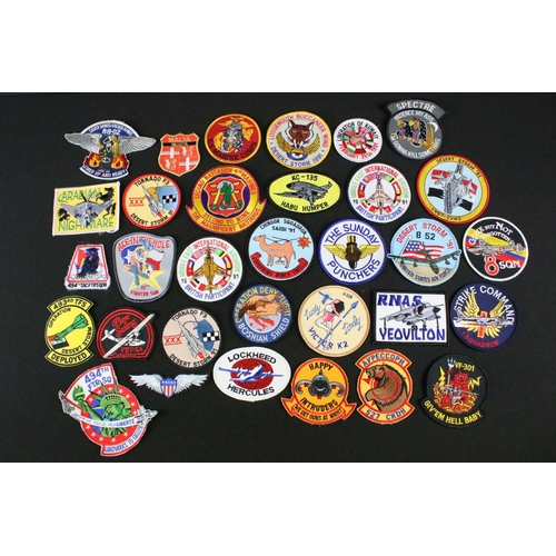 148 - A large collection of reproduction military and air force cloth badges and patches.