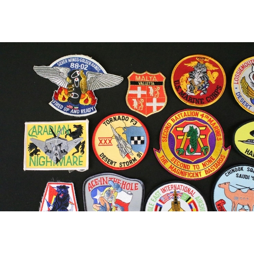 148 - A large collection of reproduction military and air force cloth badges and patches.