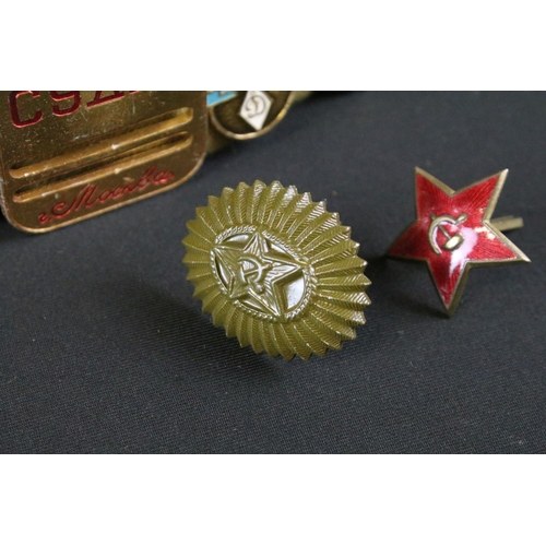 158 - A collection of Russian propaganda badges mounted to military side cap.