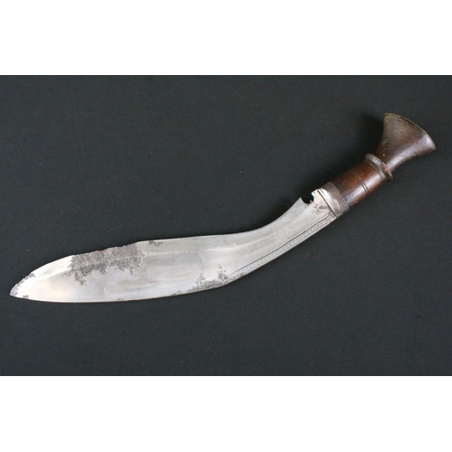 171 - An early to mid 20th century Kukri knife, engraved steel blade, turned wooden handle with flat brass... 