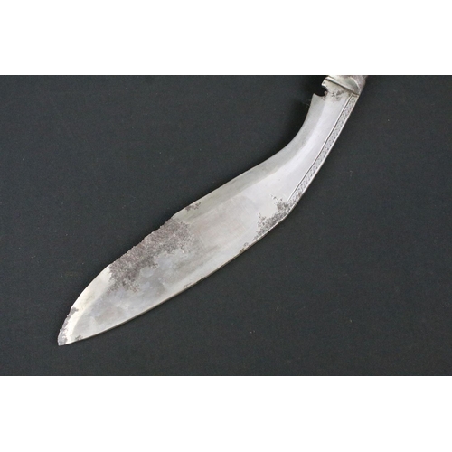 171 - An early to mid 20th century Kukri knife, engraved steel blade, turned wooden handle with flat brass... 