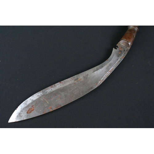 172 - A mid 20th century Kukri knife, steel blade, turned wooden handle, flat white metal pommel, blade me... 