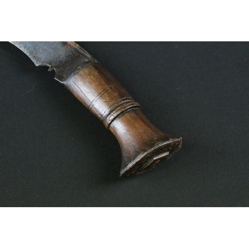 175 - A mid 20th century Kukri knife, steel blade with 8/2 stamped near spine, turned wooden handle, white... 