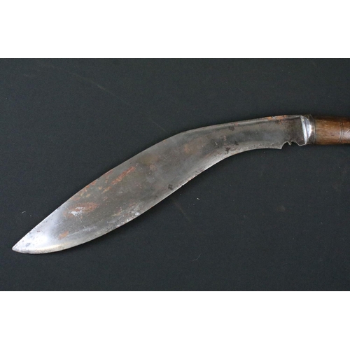 175 - A mid 20th century Kukri knife, steel blade with 8/2 stamped near spine, turned wooden handle, white... 