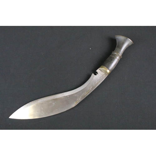 178 - A mid 20th century Kukri knife, steel blade with engraved decoration, turned horn handle, brass flat... 