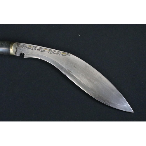 178 - A mid 20th century Kukri knife, steel blade with engraved decoration, turned horn handle, brass flat... 