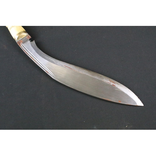 184 - A vintage early to mid 20th century Kukri knife, twin groove fullered steel blade, carved bone handl... 