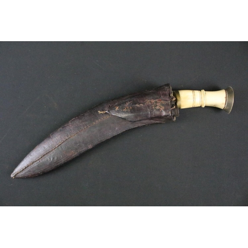 184 - A vintage early to mid 20th century Kukri knife, twin groove fullered steel blade, carved bone handl... 