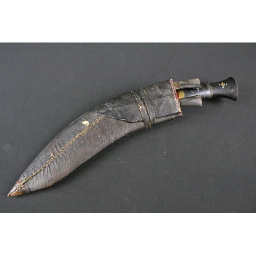 188 - A 20th century Kukri knife, engraved steel blade, carved horn handle with inlay decoration, brass fl... 