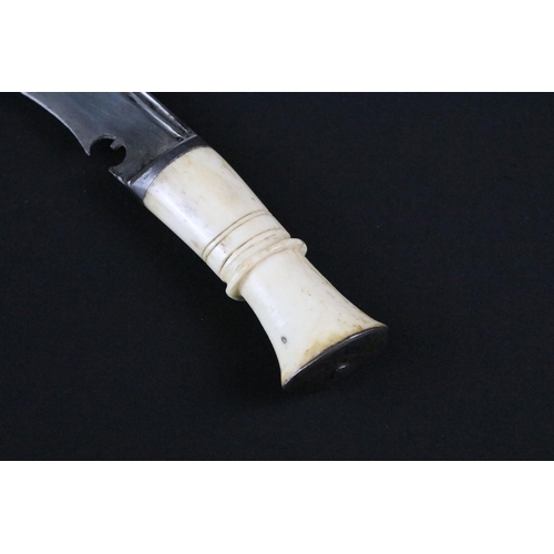 193 - An early to mid 20th century Kukri knife, twin groove fullered steel blade, turned bone handle, blad... 