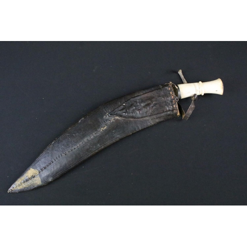 193 - An early to mid 20th century Kukri knife, twin groove fullered steel blade, turned bone handle, blad... 