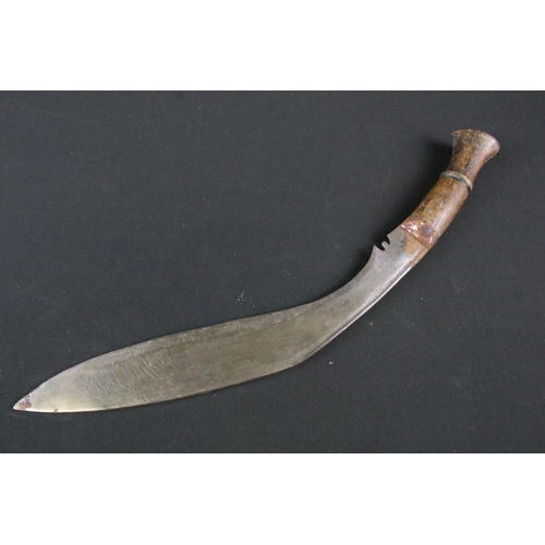 205 - An mid 20th century Kukri knife, steel blade with turned wooden handle, blade measures approx 31.5cm... 