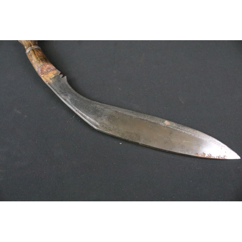 205 - An mid 20th century Kukri knife, steel blade with turned wooden handle, blade measures approx 31.5cm... 