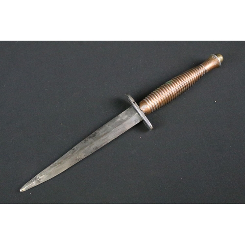 208 - An unmarked Fairbairn Sykes commando fighting knife together with sheath.