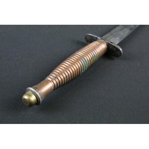 208 - An unmarked Fairbairn Sykes commando fighting knife together with sheath.