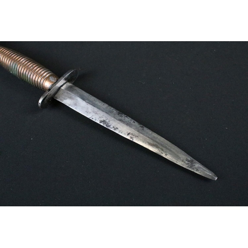 208 - An unmarked Fairbairn Sykes commando fighting knife together with sheath.