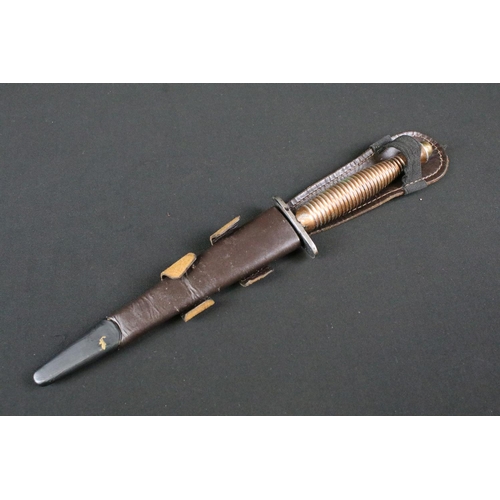 208 - An unmarked Fairbairn Sykes commando fighting knife together with sheath.