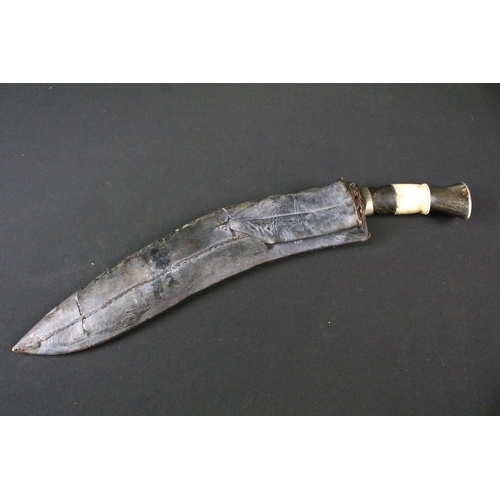 212 - A mid 20th century Chirra Kukri knife, steel blade with Chirra and grooved fullers, bone and horn ba... 