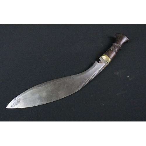 213 - A late 20th century Kukri knife, steel blade with twin grooved fullers, turned wooden handle, blade ... 