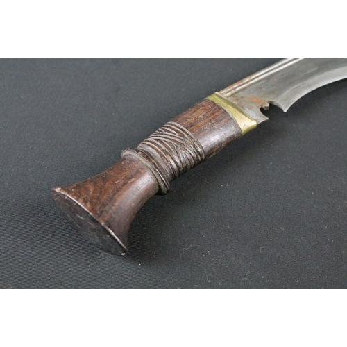 213 - A late 20th century Kukri knife, steel blade with twin grooved fullers, turned wooden handle, blade ... 