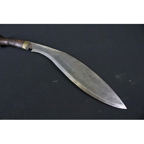 213 - A late 20th century Kukri knife, steel blade with twin grooved fullers, turned wooden handle, blade ... 