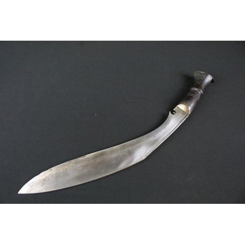 215 - A mid to late 20th century Kukri knife, steel twin groove fullered blade, turned wooden handle with ... 