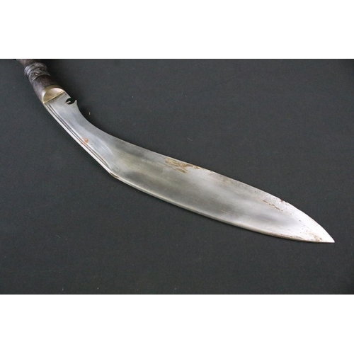 215 - A mid to late 20th century Kukri knife, steel twin groove fullered blade, turned wooden handle with ... 