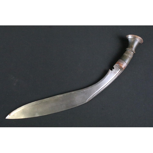 232 - A mid to late 20th century Kukri knife, steel blade with twin grooved fullers, turned and engraved h... 