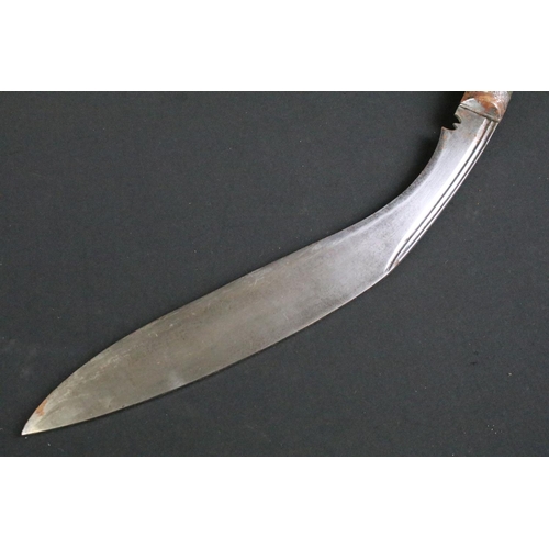 232 - A mid to late 20th century Kukri knife, steel blade with twin grooved fullers, turned and engraved h... 