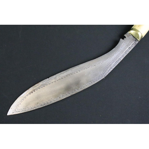 233 - A mid to late 20th century Kukri knife, steel blade with elaborate dot engraved decoration, turned b... 