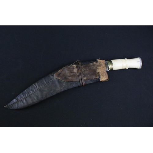 233 - A mid to late 20th century Kukri knife, steel blade with elaborate dot engraved decoration, turned b... 