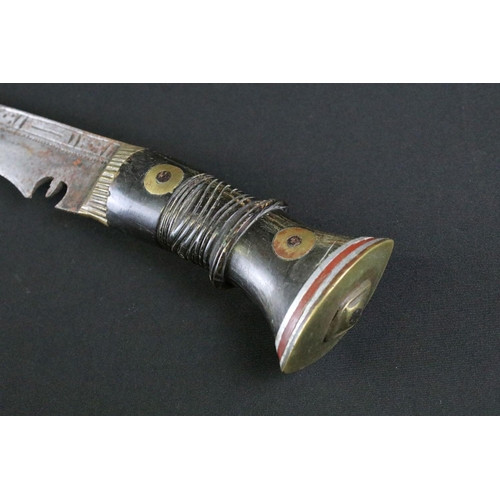 234 - A mid 20th century Kukri knife, steel blade with engraved decoration, turned and engraved riveted ha... 