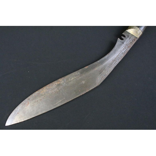 234 - A mid 20th century Kukri knife, steel blade with engraved decoration, turned and engraved riveted ha... 