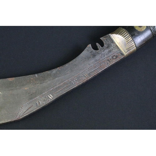 234 - A mid 20th century Kukri knife, steel blade with engraved decoration, turned and engraved riveted ha... 