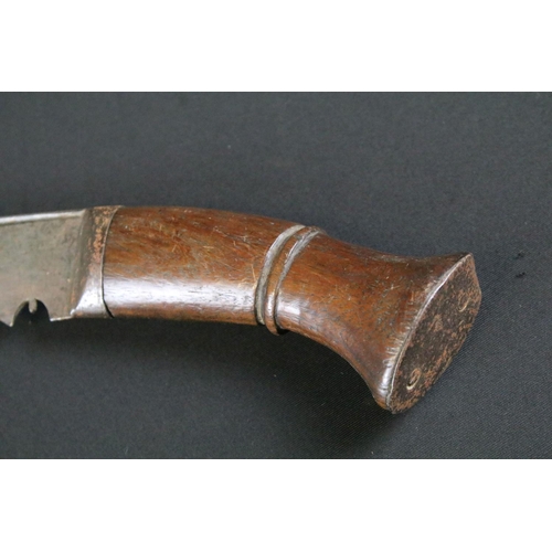 236 - A mid 20th century Kukri knife, steel blade with grooved fuller, turned wooden handle, blade measure... 