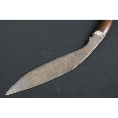 236 - A mid 20th century Kukri knife, steel blade with grooved fuller, turned wooden handle, blade measure... 