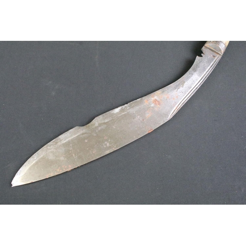 237 - A mid 20th century Kukri knife, steel blade with twin grooved fullers, turned bone handle, blade mea... 