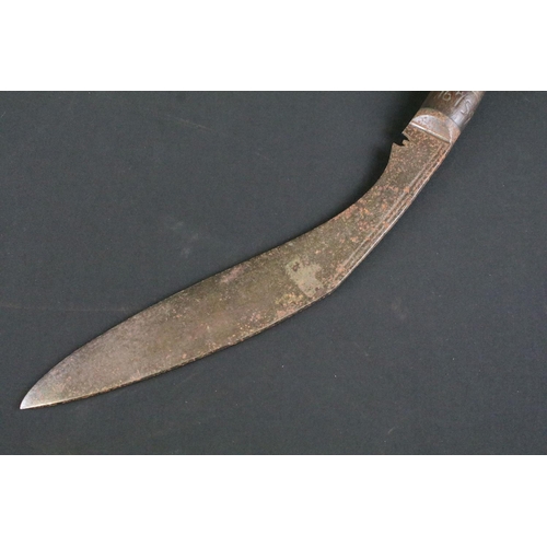 240 - A mid 20th century Kukri knife, steel blade with twin grooved fullers, turned wooden handle with han... 